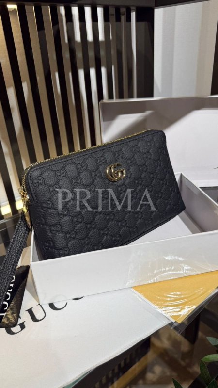 حقيبة يد (باوتش) من غوتشي (Gucci).تتميز هذه الحقيبة بعدة سمات أساسية:التصميم: جلد أسود محفور بنقشة GG الكلاسيكية (Gucci GG embossed).الشعار: يتوسطها شعار Double G باللون الذهبي.الاستخدام: تُصنف كحقيبة يد صغيرة أو "باوتش" (Pouch/Clutch) تناسب الرجال والنساء.التفاصيل: تأتي مع سحّاب معدني علوي وحزام معصم جلدي للمسك.تُعرف هذه الحقيبة أيضاً في بعض المتاجر باسم حقيبة Gucci GG Emblem.فل باكج مختومة قاعدة 24 سم